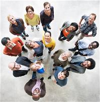 15 people standing in a circle looking up
